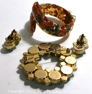 Group of Mid Century Vintage Jewelry.  Includes faceted Rhinestone Circle Brooch with Matching Clip On Earrings and Lucite Hinged Cuff Bracelet with Gold Confetti Glitter. 