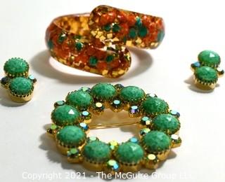 Group of Mid Century Vintage Jewelry.  Includes faceted Rhinestone Circle Brooch with Matching Clip On Earrings and Lucite Hinged Cuff Bracelet with Gold Confetti Glitter. 