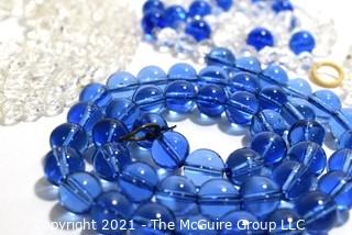 Four (4) Strands of Clear and Cobalt Blue Crystal Faceted Beads. 