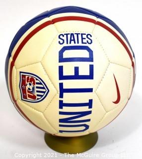 Autographed USA Soccer Ball from the 2008 Summer Olympics.  Signatures include Lauren Cheney Holiday, Stephanie Cox & Amy Rodriguez.  There are additional signatures that are illegible.  