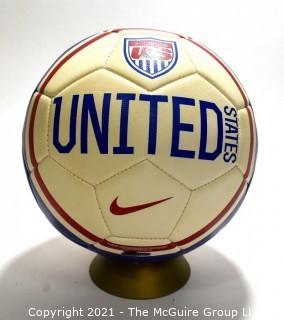 Autographed USA Soccer Ball from the 2008 Summer Olympics.  Signatures include Lauren Cheney Holiday, Stephanie Cox & Amy Rodriguez.  There are additional signatures that are illegible.  