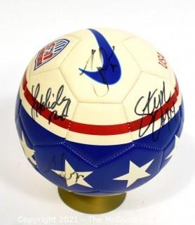 Autographed USA Soccer Ball from the 2008 Summer Olympics.  Signatures include Lauren Cheney Holiday, Stephanie Cox & Amy Rodriguez.  There are additional signatures that are illegible.  