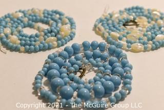 Three (3) Strands of Blue Glass and Mother of Pearl Beads. 