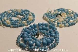 Three (3) Strands of Blue Glass and Mother of Pearl Beads. 