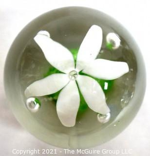 Vintage Round Hand Blown Lampwork Glass Paperweight with White & Green Flower. Measures 3" in diameter.