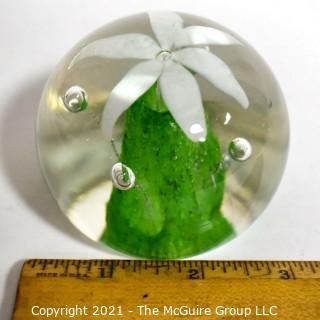 Vintage Round Hand Blown Lampwork Glass Paperweight with White & Green Flower. Measures 3" in diameter.