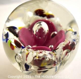 Vintage Round Hand Blown Lampwork Glass Paperweight with Pink Flower. Measures 3" in diameter.