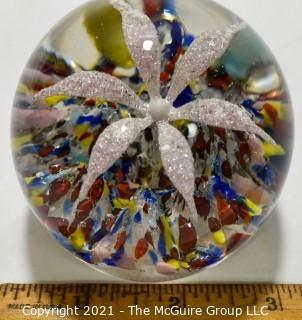 Vintage Round Hand Blown Lampwork Glass Paperweight with White Flower. Measures 3" in diameter.