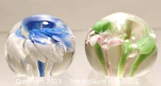 Two (2) Vintage Round Hand Blown Lampwork Glass Paperweights with Blue & Green Flowers. Measures 2" in diameter.