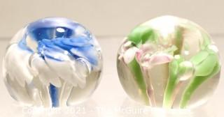 Two (2) Vintage Round Hand Blown Lampwork Glass Paperweights with Blue & Green Flowers. Measures 2" in diameter.