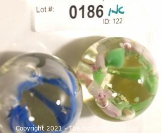 Two (2) Vintage Round Hand Blown Lampwork Glass Paperweights with Blue & Green Flowers. Measures 2" in diameter.