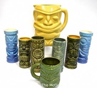 Seven (7) Tiki Mugs Or Tumblers with Pitcher in Blue and Yellow.  Includes two (2) Virginia Distillery Mugs and one (1) Luau Hut cup. Barware. 