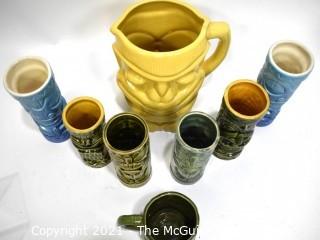 Seven (7) Tiki Mugs Or Tumblers with Pitcher in Blue and Yellow.  Includes two (2) Virginia Distillery Mugs and one (1) Luau Hut cup. Barware. 