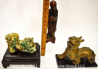 Three (3) Asian Statues Including Ceramic & Metal Foo Dog & Carved Elder. 