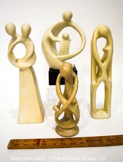 Four (4) Hand Carved Soapstone Sculptures of People Embracing 