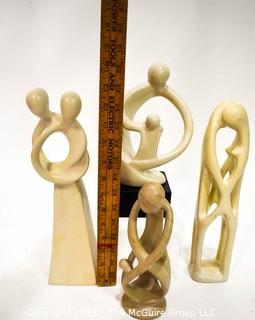 Four (4) Hand Carved Soapstone Sculptures of People Embracing 