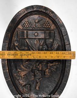 Heavy Cast Iron Oval Plaque of Monks in the Wine Cellar. 18" x 12".