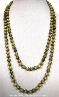 Vintage Opera Length Green & White Mottled Textured Beads with Screw Claps.  Measures 52" long.