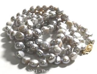 Opera Length Grey Freshwater Coin Pearl Necklace with 14k Gold Clasp.  Measures 32" long.  