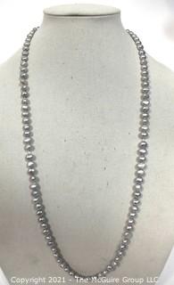 Opera Length Grey Freshwater Coin Pearl Necklace with 14k Gold Clasp.  Measures 32" long.  