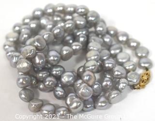 Opera Length Grey Freshwater Coin Pearl Necklace with 14k Gold Clasp.  Measures 32" long.  