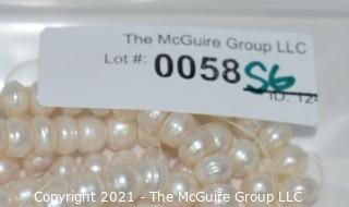 Strand of White Potato Round Freshwater Pearls.  Measures 48" long. 