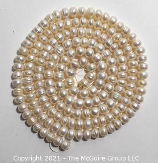 Strand of White Potato Round Freshwater Pearls.  Measures 48" long. 