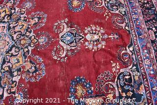 Hand Woven Persian Wool Rug with Medallion Center on Red Ground with Blue Border. Some wear. 
 Measures 115" x 155"