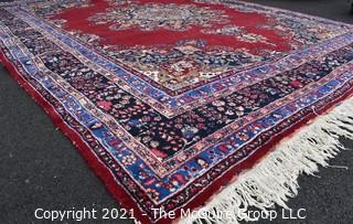 Hand Woven Persian Wool Rug with Medallion Center on Red Ground with Blue Border. Some wear. 
 Measures 115" x 155"