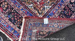 Hand Woven Persian Wool Rug with Medallion Center on Red Ground with Blue Border. Some wear. 
 Measures 115" x 155"