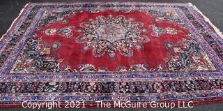 Hand Woven Persian Wool Rug with Medallion Center on Red Ground with Blue Border. Some wear. 
 Measures 115" x 155"