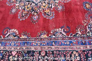 Hand Woven Persian Wool Rug with Medallion Center on Red Ground with Blue Border. Some wear. 
 Measures 115" x 155"