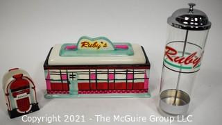 Three Piece Set of Ruby's Roadside Diner Decorative Items Including Cookie Jar, Straw Dispenser and Napkin Holder.   