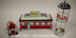 Three Piece Set of Ruby's Roadside Diner Decorative Items Including Cookie Jar, Straw Dispenser and Napkin Holder.   