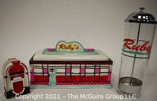 Three Piece Set of Ruby's Roadside Diner Decorative Items Including Cookie Jar, Straw Dispenser and Napkin Holder.   