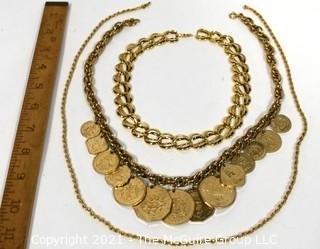 Three Chunky Gold Tone Necklaces Including One With Coins.