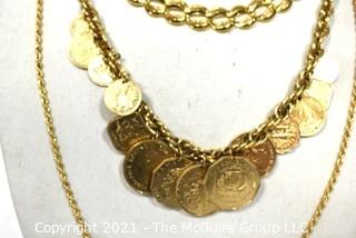 Three Chunky Gold Tone Necklaces Including One With Coins.