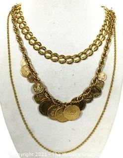 Three Chunky Gold Tone Necklaces Including One With Coins.