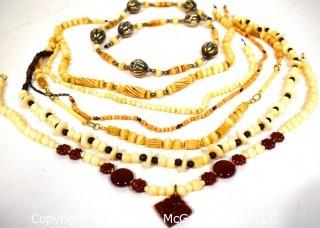 Seven (7) Strands of Carved Bone and & Garnet Beads.