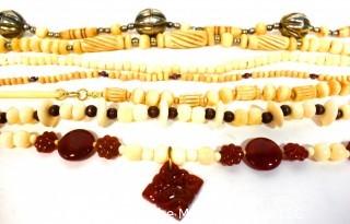 Seven (7) Strands of Carved Bone and & Garnet Beads.