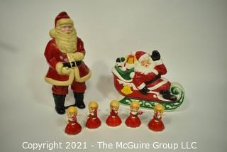 Vintage Christmas Decorations Including Celluloid Santa, Blow Mold Santa and Five Porcelain Angle Candlesticks.