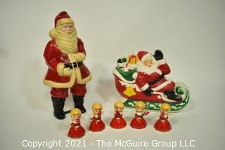 Vintage Christmas Decorations Including Celluloid Santa, Blow Mold Santa and Five Porcelain Angle Candlesticks.