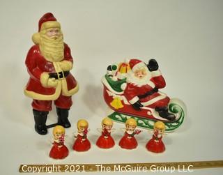 Vintage Christmas Decorations Including Celluloid Santa, Blow Mold Santa and Five Porcelain Angle Candlesticks.