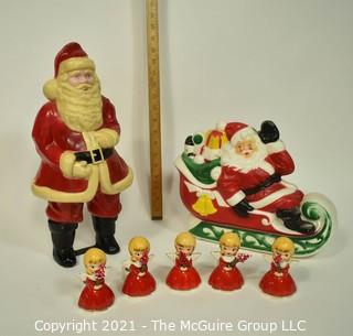 Vintage Christmas Decorations Including Celluloid Santa, Blow Mold Santa and Five Porcelain Angle Candlesticks.