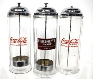 Three (3) Glass & Chrome Soda Fountain Straw Dispensers with Coca Cola & Hershey Logos