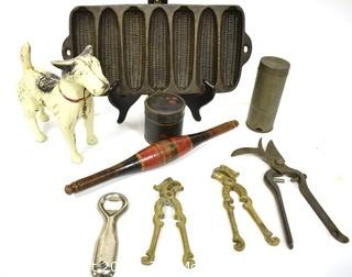 Collection of Primitive Tools.  Includes Terrier Dog Cast Iron Door Stop, Painted Naan Roller, Ware Cast Iron Corn Bread Pan, Tole Painted Tin, Nutmeg Grater, LaBatt's Bottle Opener, (2) Brass Nutcrackers & French Vineyard Shears.  {Note: Description Altered 10.14.2021 @ 6:46pm ET}