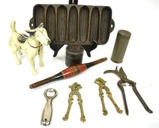 Collection of Primitive Tools.  Includes Terrier Dog Cast Iron Door Stop, Painted Naan Roller, Ware Cast Iron Corn Bread Pan, Tole Painted Tin, Nutmeg Grater, LaBatt's Bottle Opener, (2) Brass Nutcrackers & French Vineyard Shears.  {Note: Description Altered 10.14.2021 @ 6:46pm ET}