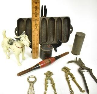 Collection of Primitive Tools.  Includes Terrier Dog Cast Iron Door Stop, Painted Naan Roller, Ware Cast Iron Corn Bread Pan, Tole Painted Tin, Nutmeg Grater, LaBatt's Bottle Opener, (2) Brass Nutcrackers & French Vineyard Shears.  {Note: Description Altered 10.14.2021 @ 6:46pm ET}