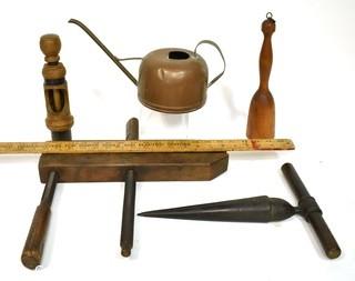 Group of Primitive Tools Including Copper Watering Can, Wood Clamp with Wooden Screws, Cast Iron Reamer, and Wooden Potato Masher. {Note: Description Altered 10.14.2021 @ 6:46pm ET}