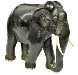 Large Asian Rosewood Carved Elephant Statue with Bone Tusks.  Measures 9" x 18" x 21". Consignor states it was an artifact in Senate Majority Leader Howard Baker's office.  